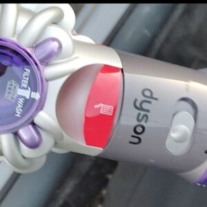 Dyson Vacuum Cleaner with Purple and Red Accents